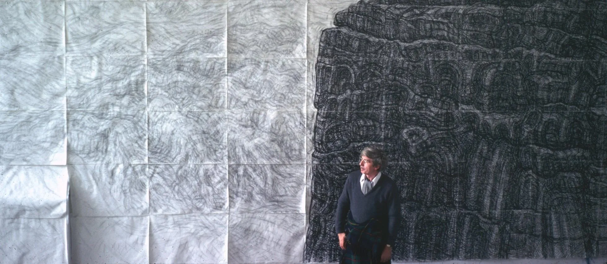 Leonard standing in front of his Rock and Sea Anglesey drawing.