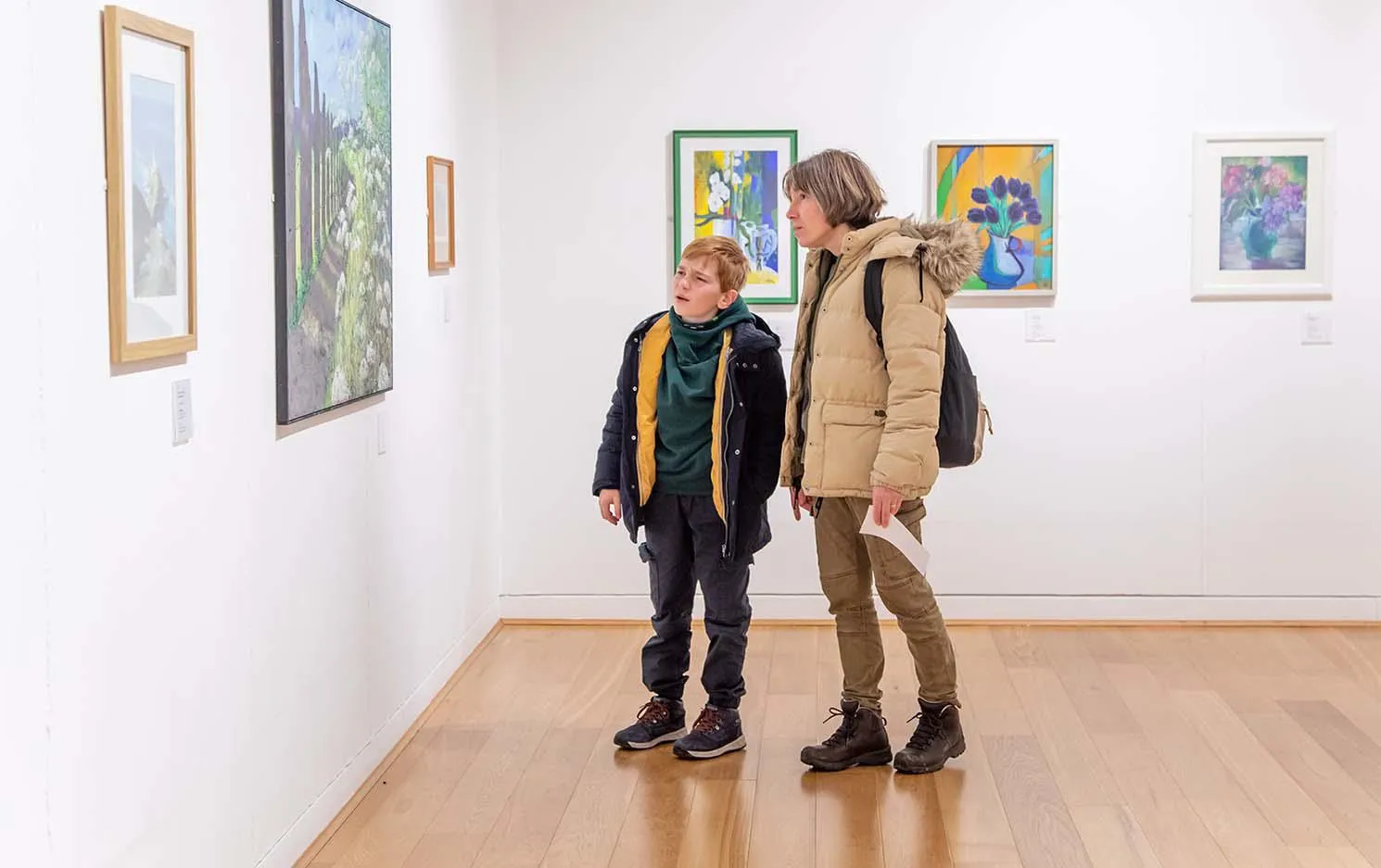 A woman and a boy studying an artwork in the Art Gallery